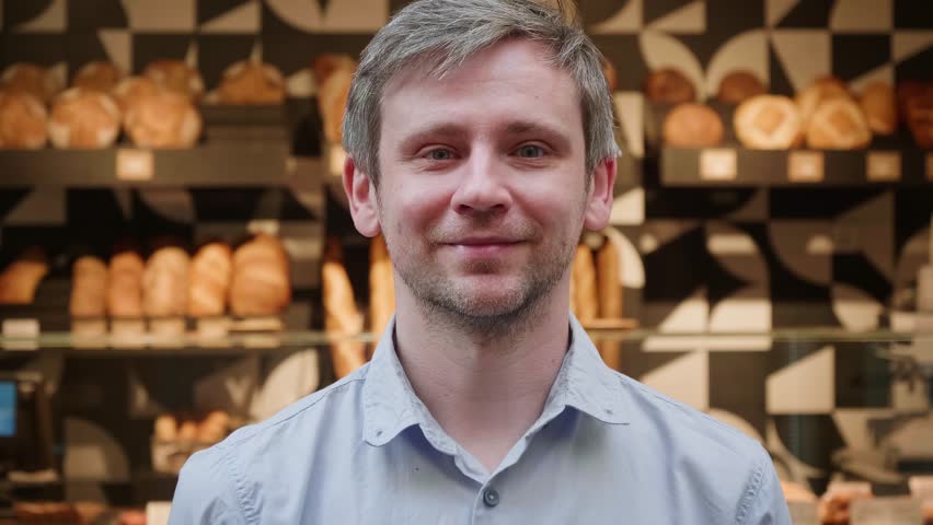 Handsome businessman bakery owner portrait. Happy young man posing outdoor, male model looking in camera with smile close-up, guy tourist standing in street. 