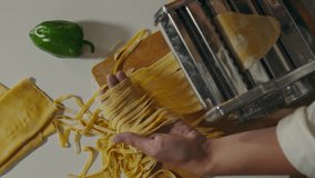 Pasta, cook baker preparing Rolls out dough with roller press in pasta laboratory. The concept of a skilled worker stands at the workplace masters new pasta cooking techniques, manual machine
 - Powered by Shutterstock - Get 15% off with code: PIKWIZARD15