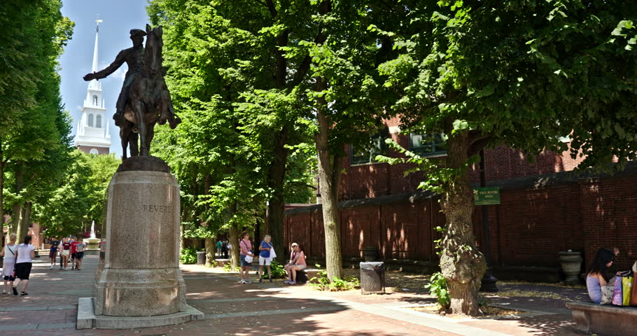 Boston, USA - July 19, 2022: Paul Revere statue on the historic Boston Freedom Trail with the Old North Church steeple in behind in Boston Massachusetts USA