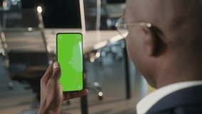 Tap to Click on Centre of Screen. Green Screen and Chroma Key of Smartphone. Businessman Using Smart Phone for Work. Office Worker Connects to Chat or Video Conference. Greenscreen of Chromakey Mock - Powered by Shutterstock - Get 15% off with code: PIKWIZARD15