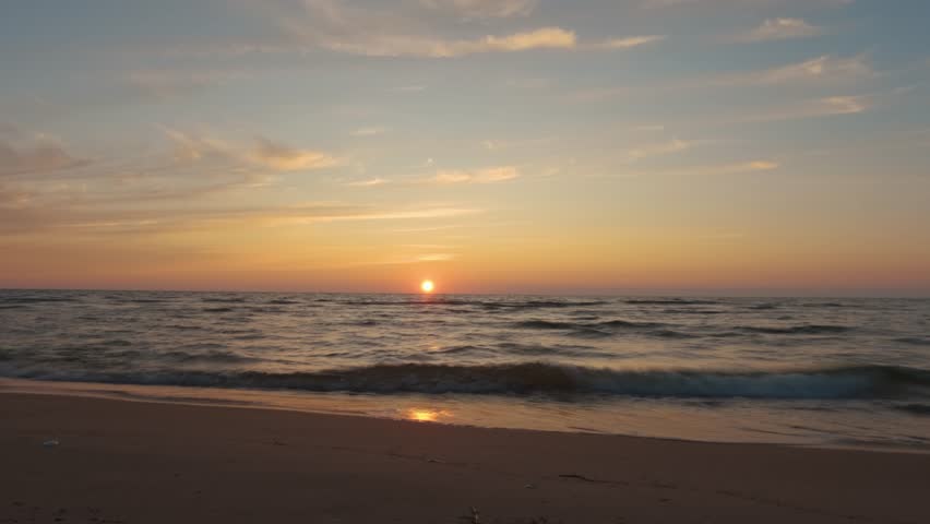 Timelapse View of the Baltic Sea at Sunset, Irbe, Latvia. Beautiful Golden Sunset Over the Beach Seascape. Glittering Sunlight Reflection. The Baltic Sea at the Mouth of Irbe River in Courland