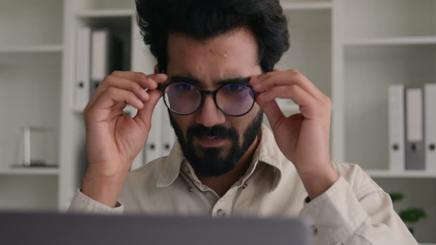 Unhealthy Indian Arabian man in glasses for laptop business work confused businessman office ceo with bad eyesight blurry vision eyes myopia take off spectacles medical eye laser correction loss sight Royalty-Free Stock Footage #1105748683