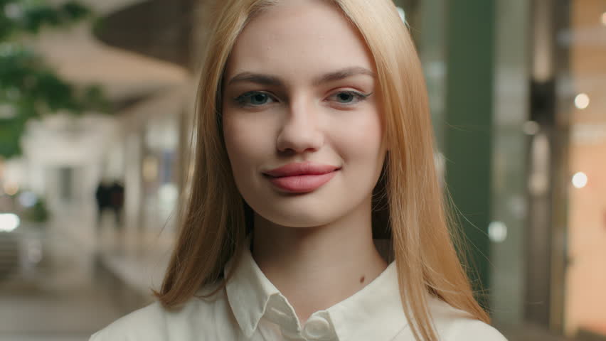 Close up portrait attractive 20s blonde girl Caucasian office businesswoman woman with long healthy hair looking at camera blowing wind flying hairstyle female model advertise beauty cosmetic shampoo