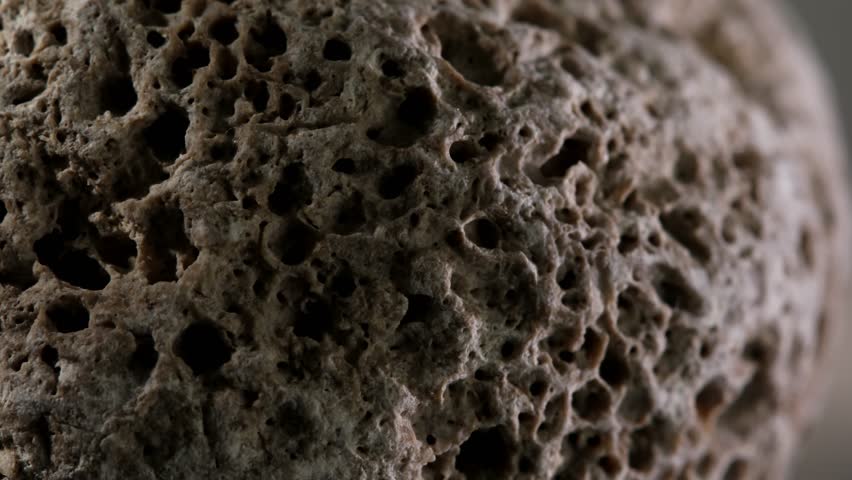 macro shot of a rock. sponge stone texture close-up. rought mountain surface. geological exploration. natural mineral background. 