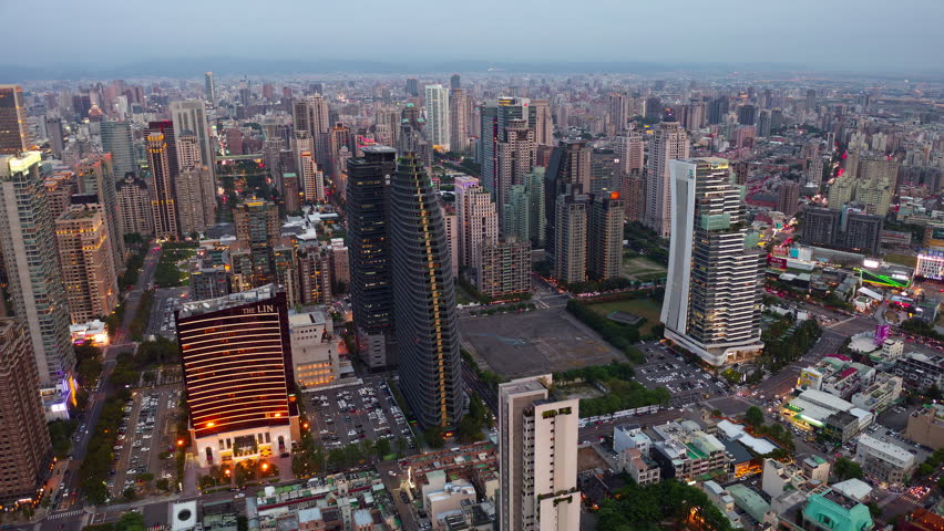 Aerial skyline of Downtown Taichung, a vibrant metropolis in central Taiwan, with modern high-rise office towers booming in the 7th Redevelopment Zone and city lights dazzling at night (in hyperlapse)