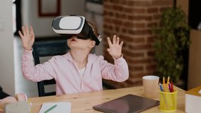 Innovative primary learning. Cute little girl wearing virtual reality glasses enjoying futuristic lesson, turning head and pushing invisible buttons, tracking shot, slow motion, free space - Powered by Shutterstock - Get 15% off with code: PIKWIZARD15
