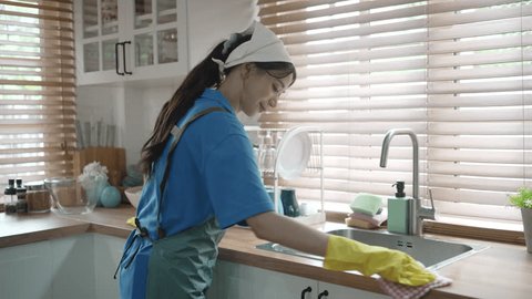 Стоковое видео: House keeper clean kitchen. Cleaning service and house keeping concept.
