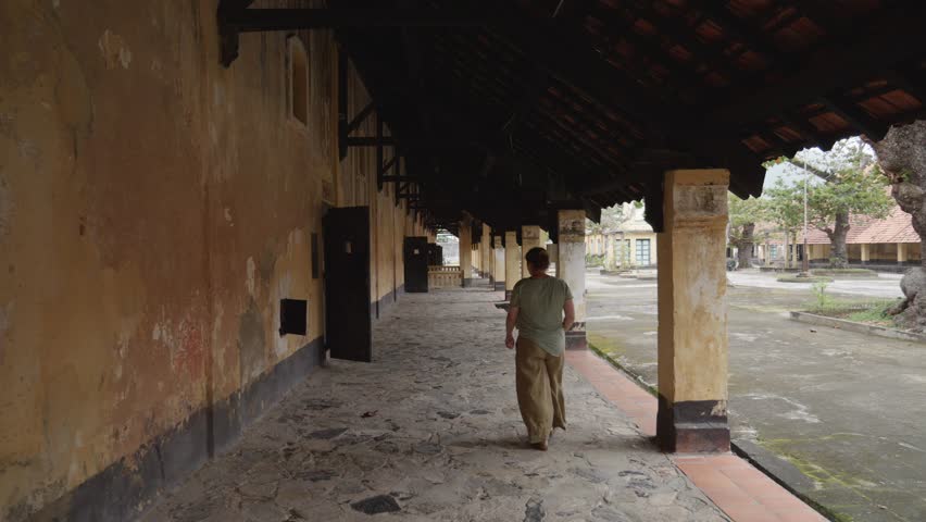 Woman sightseeing The Ancient Prison Camp In Con Dao, Ba Ria Vung Tau In Vietnam. Slow Motion