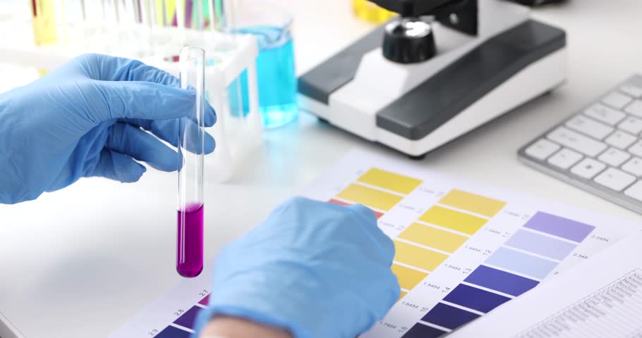 Scientist holding test tube with reagent and analyzing it on scale of acidity Royalty-Free Stock Footage #1105769251