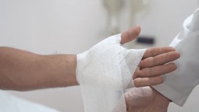 Medical bandage. Medical bandage on patient hand in clinic. Traumatology. Hospital. Injured. Therapy. Care. High quality 4k footage - Powered by Shutterstock - Get 15% off with code: PIKWIZARD15