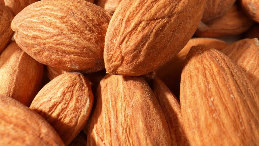 Macro video showcases almond kernels: Exquisite details of smooth texture, golden hue, and intricate patterns, capturing nature