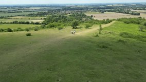 Drone Shot Of Mature Couple Walking With Pet Dog Through Beautiful English Countryside In Oxfordshire England UK - Powered by Shutterstock - Get 15% off with code: PIKWIZARD15