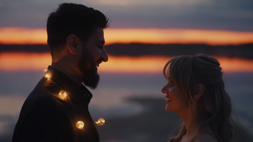 Handsome Bearded Man Putting Garland On His Beloved Woman In Romantic Date On Shore, Tender Kiss | Shutterstock HD Video #1105772091