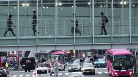 SHIBUYA, TOKYO, JAPAN : Aerial view of crowd of people walking at the pedestrian deck. Street and road traffic under the deck. Japanese city life and transportation concept video. Time lapse shot.