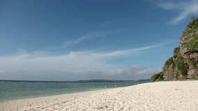 OKINAWA, JAPAN - JUL 2021 : View of Sesoko beach(Ocean or sea) at Sesoko island. Clear blue sunny sky and clouds. Wide view, time lapse shot in day. Summer holiday, vacation and resort concept video.
