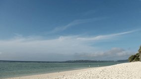 OKINAWA, JAPAN - JUL 2021 : View of Sesoko beach(Ocean or sea) at Sesoko island. Clear blue sunny sky and clouds. Wide view, time lapse shot in day. Summer holiday, vacation and resort concept video.