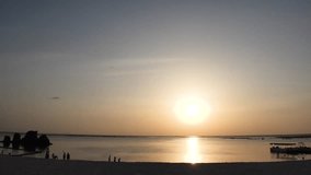 CHTAN-CHO, OKINAWA, JAPAN - AUG 2021 : View of Araha beach (Ocean or sea) in sunset time. Wide view, long time lapse shot, dusk to night. Summer holiday, vacation and resort concept 4K video.