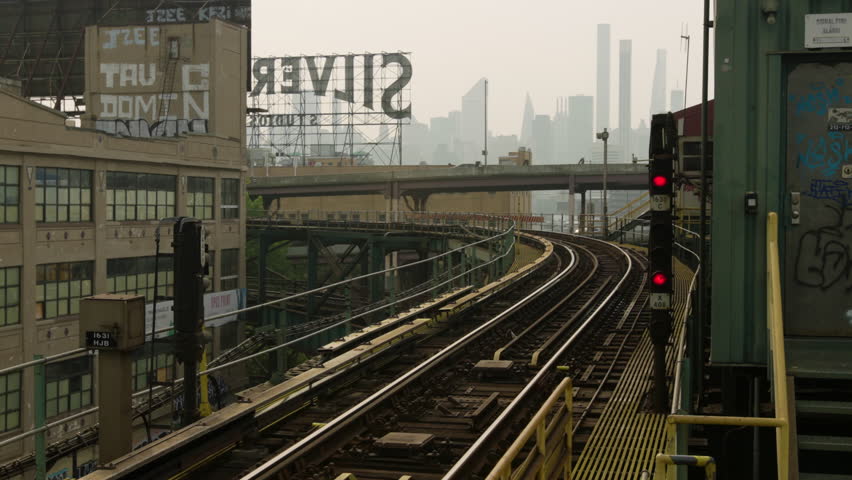 New York , United States - 07 01 2023: New York City's 7 Train Approaching Queensboro Plaza Station On Hazy Afternoon