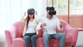 young couple having fun playing video games with virtual reality glasses at home - Powered by Shutterstock - Get 15% off with code: PIKWIZARD15