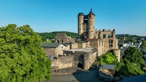 Historic Greifenstein castle in Hesse, Germany. Ruin partly renovated. Aerial 4K revealing video in summer in sunrise light
