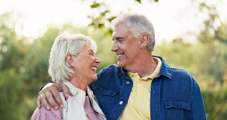 Kiss, face and senior couple in nature, having fun and bonding together. Portrait, romance and happy elderly man and woman with funny laugh, smile and enjoy quality time outdoor on vacation for love.
