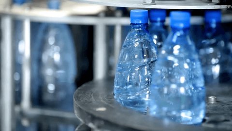 Pet Bottles on the Production Lines water filling bottle plastic factory food and beverage process Video Stok