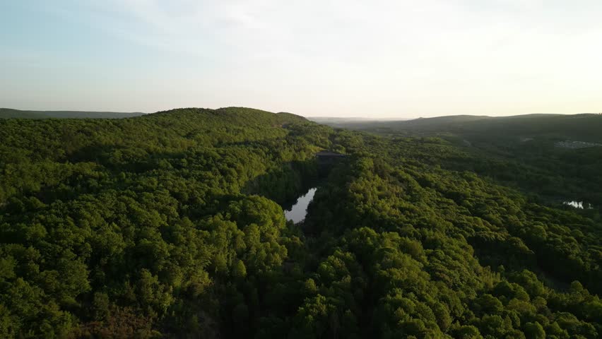 Sunset aerial over forest and pond in eastern Pennsylvania at sunset near Hazleton