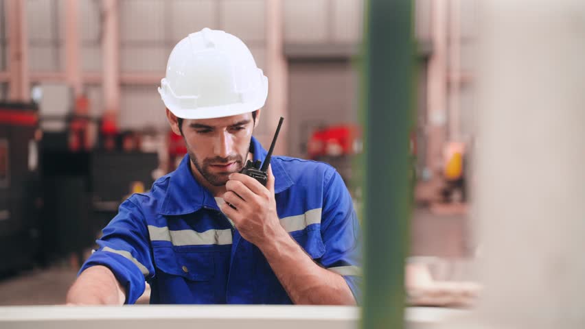 Expert Technician Engineer man in safety uniform talking by walkie talkie and using Computer Numerical Control machine in warehouse at steel factory Royalty-Free Stock Footage #1105799675