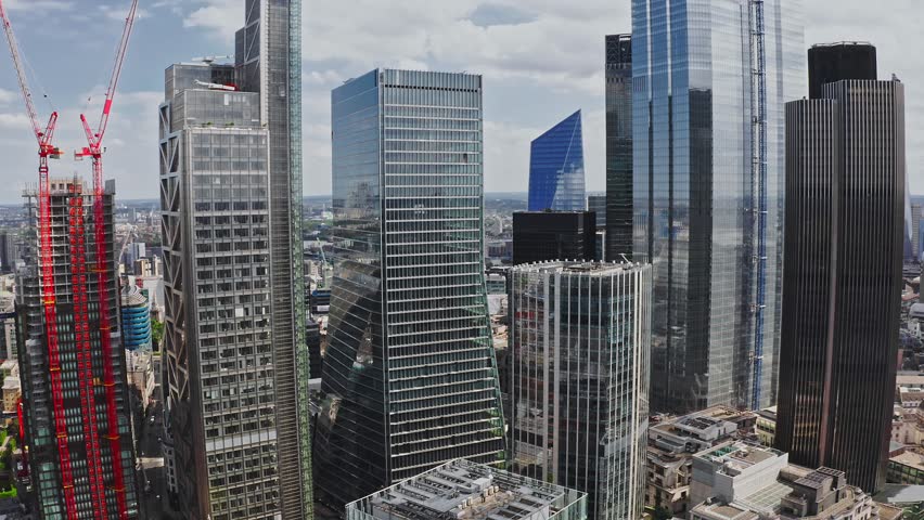 Aerial view of the city of London. Close up view of the skyscrapers from above. Panoramic skyline view of Bank and Canary Wharf, central London's leading financial districts Royalty-Free Stock Footage #1105804527