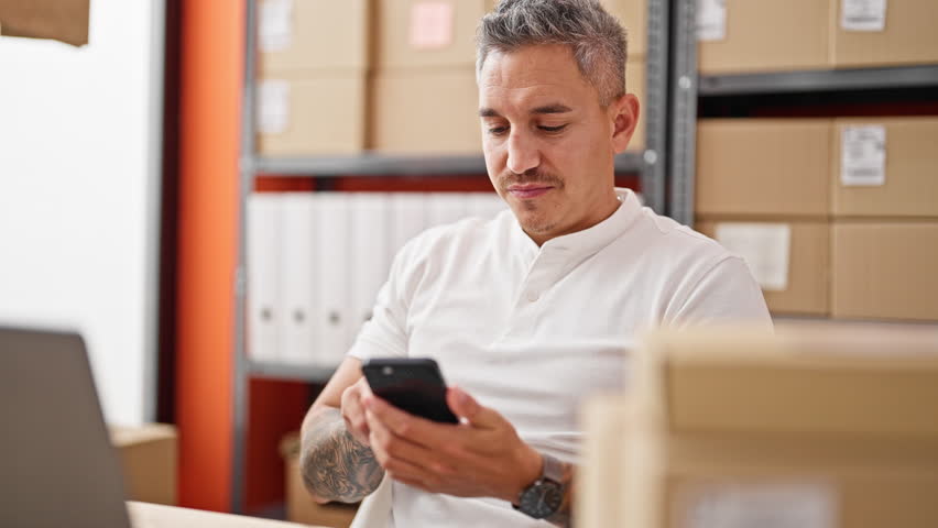 Young hispanic man ecommerce business worker using smartphone celebrating at office - Powered by Shutterstock - Get 15% off with code: PIKWIZARD15