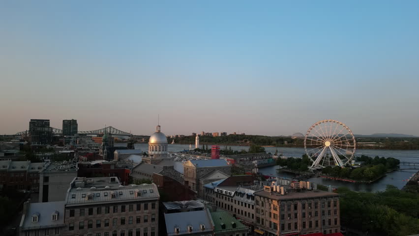 Aerial Shot Flying Over Montreal City Skyline, Ferris Wheel And Old Port At Sunset