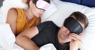 young frightened man takes off sleep mask and sees unfamiliar sleeping woman next to him 4k movie