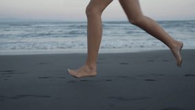 Barefoot athletic woman runs along the sand along the ocean . Legs of a fitness lady jogging outdoors on the seashore, side view. Close-up shot - Powered by Shutterstock - Get 15% off with code: PIKWIZARD15