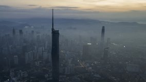 Aerial view hyperlapse 4k video of Kuala Lumpur city center view during dawn overlooking the city skyline in Federal Territory, Malaysia. Pan left