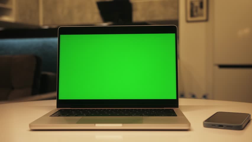 Close up of modern chroma key green screen laptop set up for work on desk at night, concept of remote work, technology concept. Royalty-Free Stock Footage #1105815505