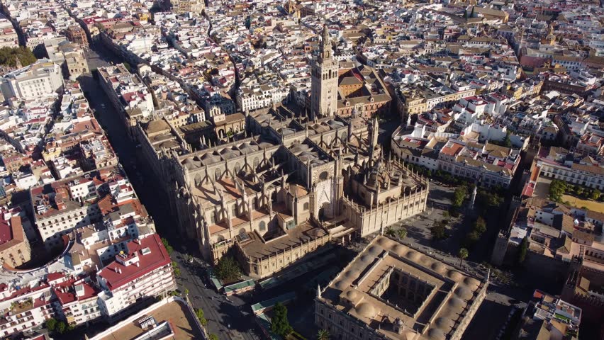 Seville, Spain: Aerial drone footage of famous Sevilla cathedral and the Giralda tower in Andalusia largest city. 
