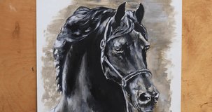The artist paints an acrylic portrait of a black horse with a brush