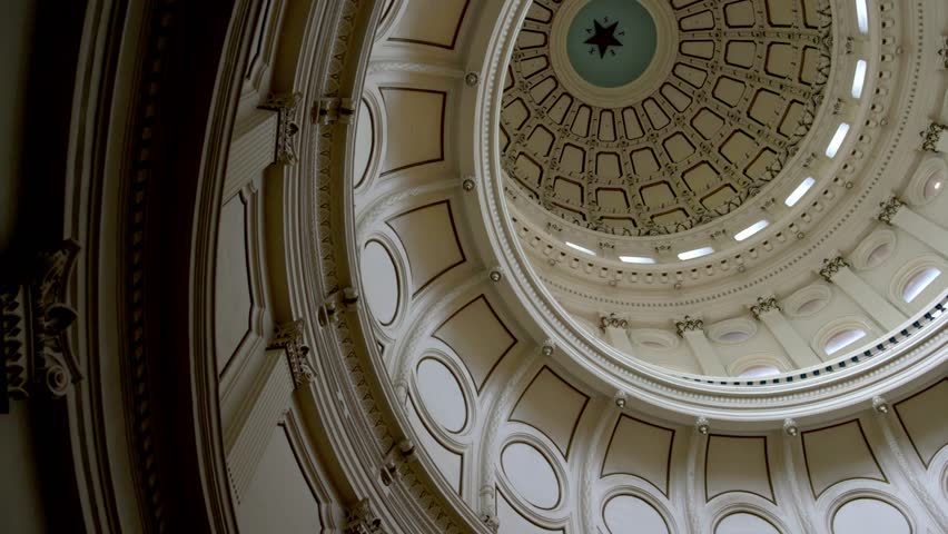 Dome inside of the Texas state capitol building with gimbal video panning in slow motion.