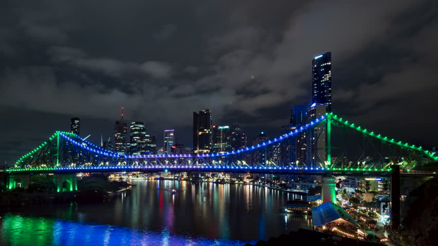 Iconic Story Bridge over Brisbane River, Australia. Blue, green lights, night timelapse.