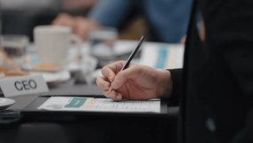 Close up hands of businesswoman taking note at meeting in paperwork on clipboard for meeting minutes. Businesswoman write records at meeting table - Powered by Shutterstock - Get 15% off with code: PIKWIZARD15