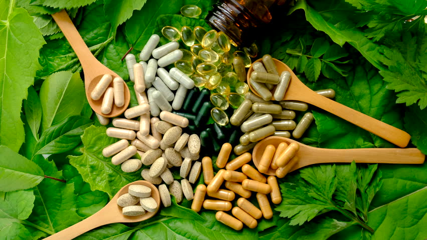 Homeopathy leaves tablets and capsules. Selective focus.