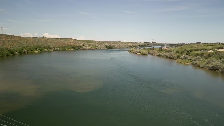 Aerial ascending over Snake River in Burley Idaho through agriculture lands