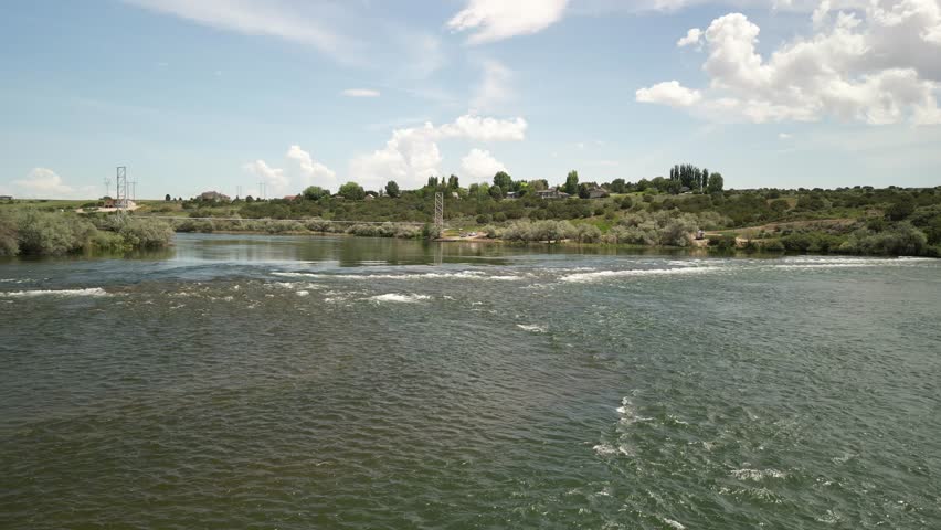 Aerial over Snake River in burley Idaho with ripples pull out over dry desert land