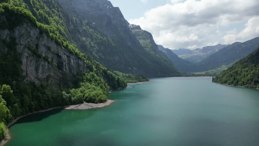 Magnificent lake stream with mountains in the background.Switzerland. Panning view