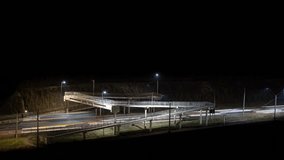 Night Timelapse of Pedestrian Bridge and Highway with Car Light Trails