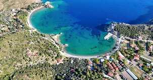Aerial drone video unveiling the scenic splendor of Hayıtbükü Bay, with its clear turquoise waters and lush landscape in Datça, Muğla, Turkey.