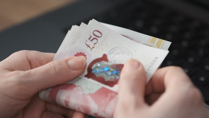 Unrecognizable Woman Counting Money. Close Up Shot of Pound Banknotes that Official Currency of England. Royalty-Free Stock Footage #1105834169