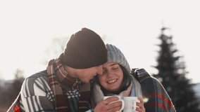 A fascinating shot shows a young family reliving moments of warmth of a delicious hot drink and enjoying the tranquility of a sunny winter day. Camping together - Powered by Shutterstock - Get 15% off with code: PIKWIZARD15