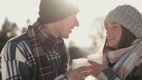 Video unforgettable journey into world emotions when couple experiences true happiness and joint vacation during winter holidays. Romance smiling and happy people relaxing in nature with cup hot drink