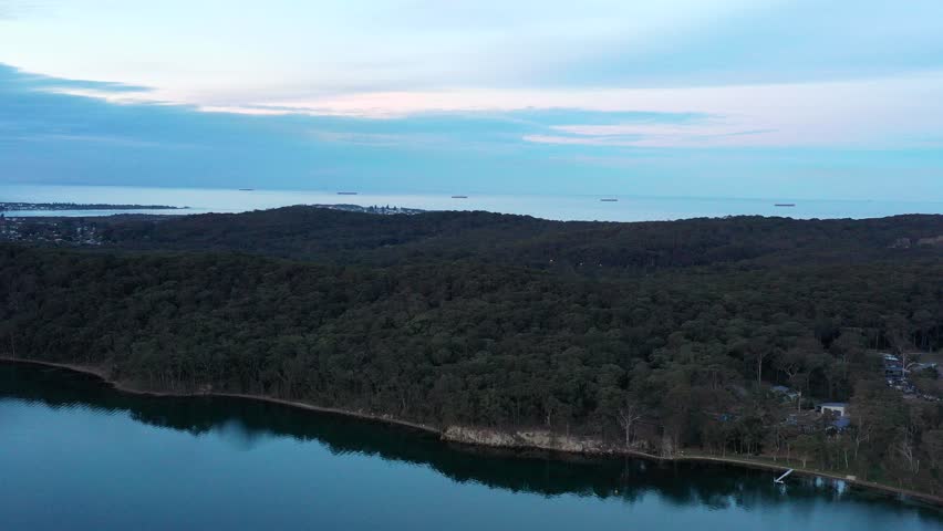 Sunset aerial panorama of Lake Macquarie lagoon on Pacific coast as 4k.
 Royalty-Free Stock Footage #1105835327